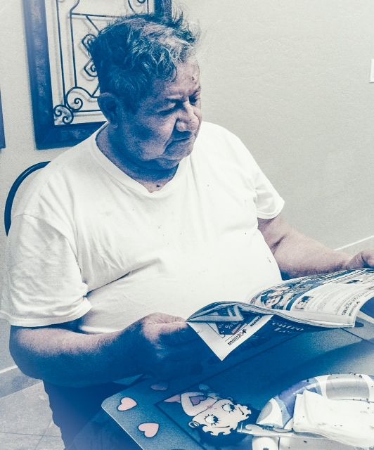 man looking at magazine